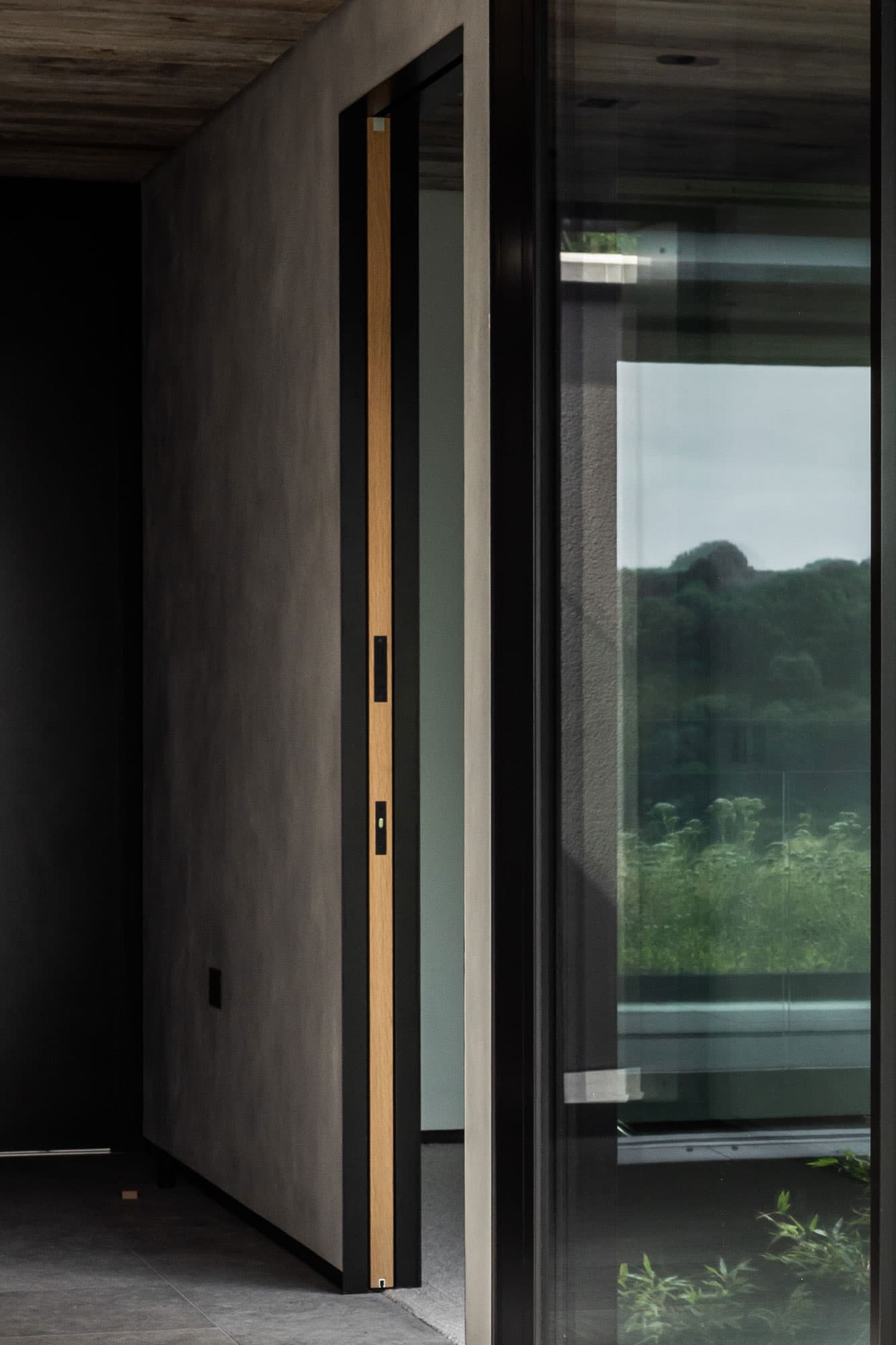 side view of a minimal sliding door fully hidden within the wall