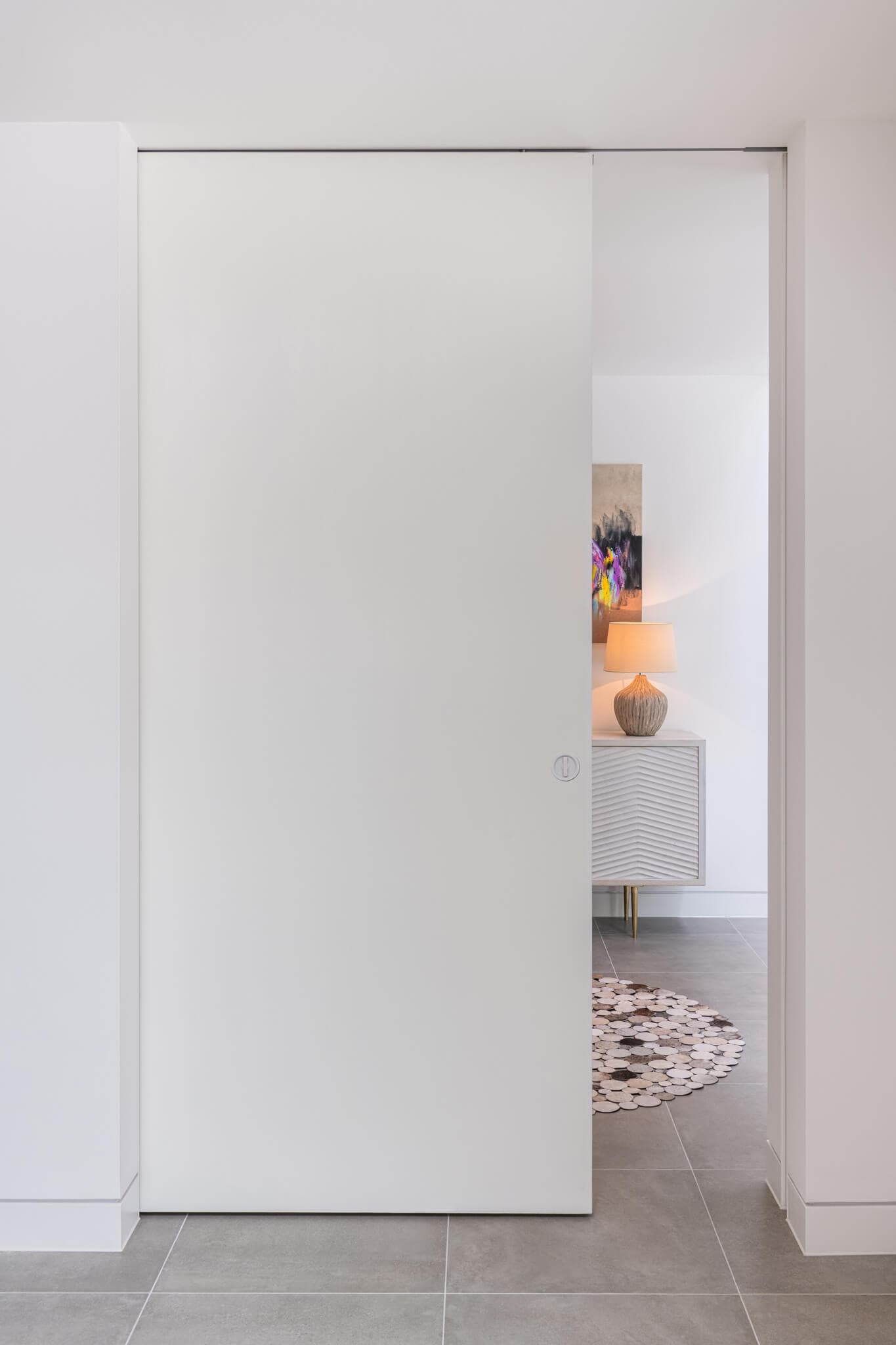 a wide pocket door partially open an sliding into the wall