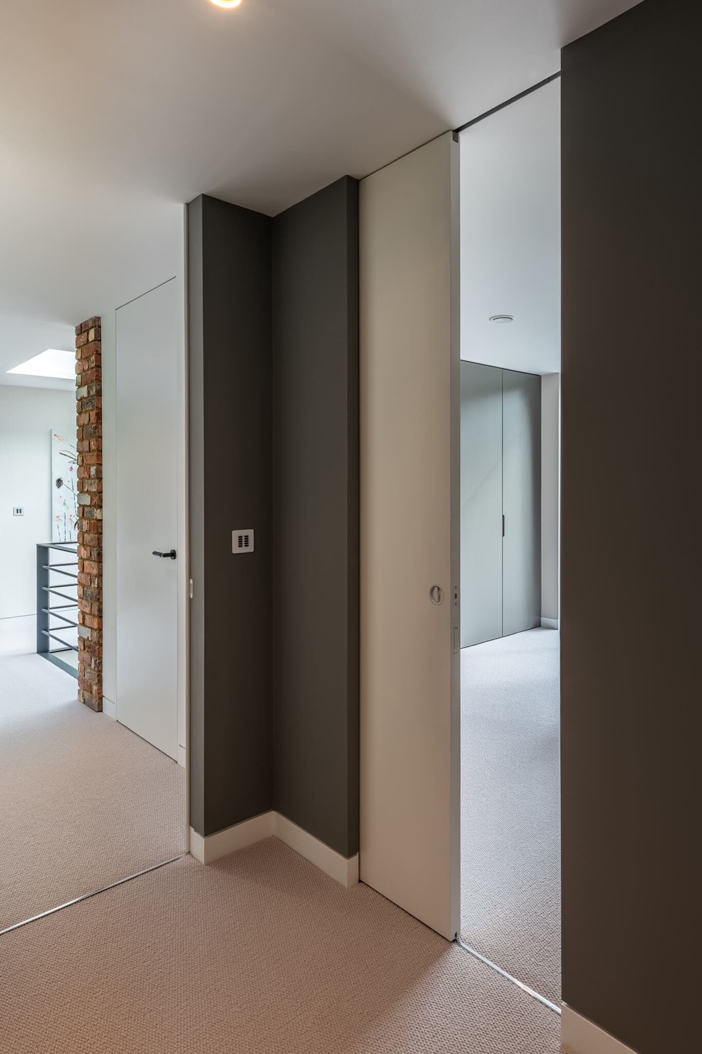 a partially open sliding door leading into a bedroom