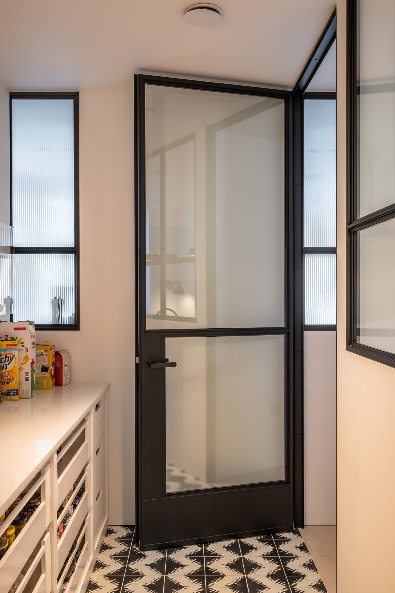 hinged sealed steel glazed internal door leading to a pantry and wine room