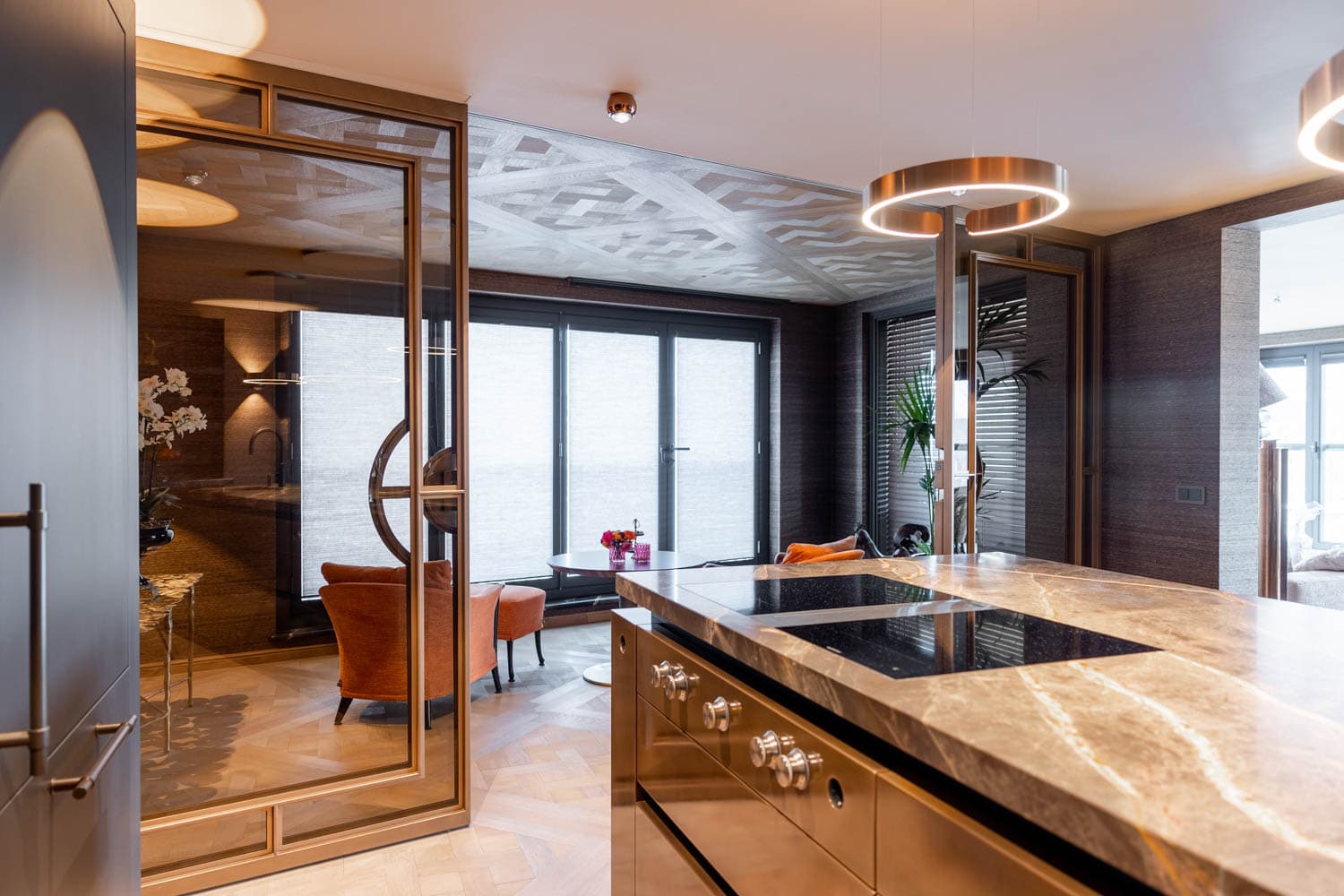 bronze finish sliding steel glazed doors creating a room divider between the kitchen and sitting room