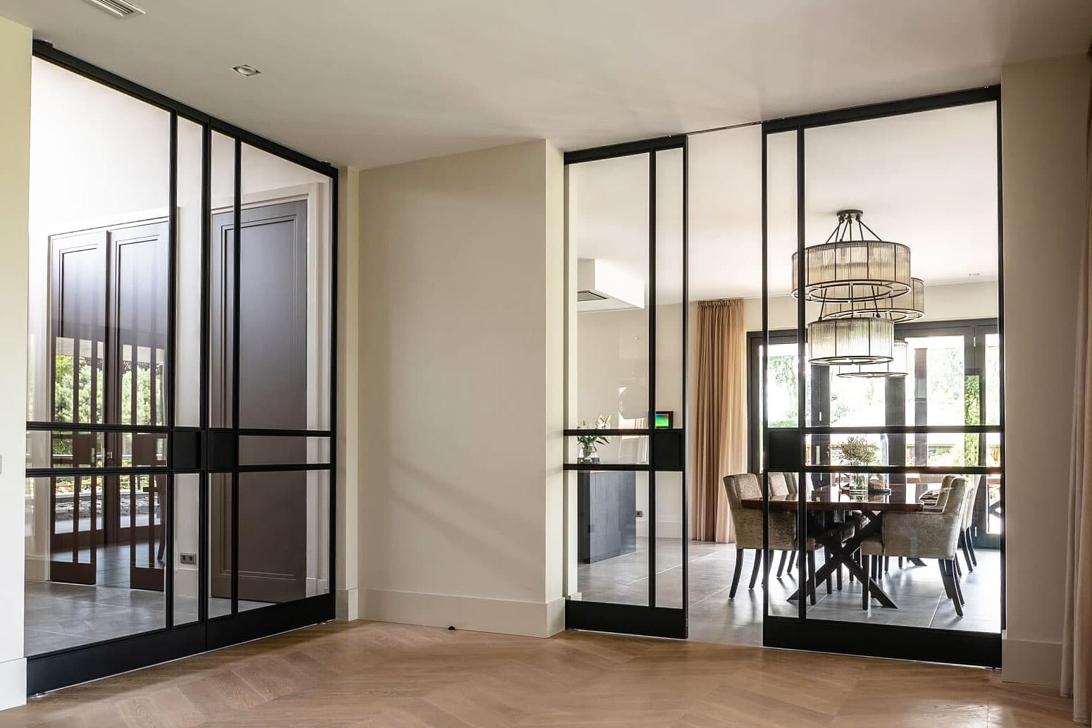 sliding double steel glazed doors in a black finish seen n a high end penthouse