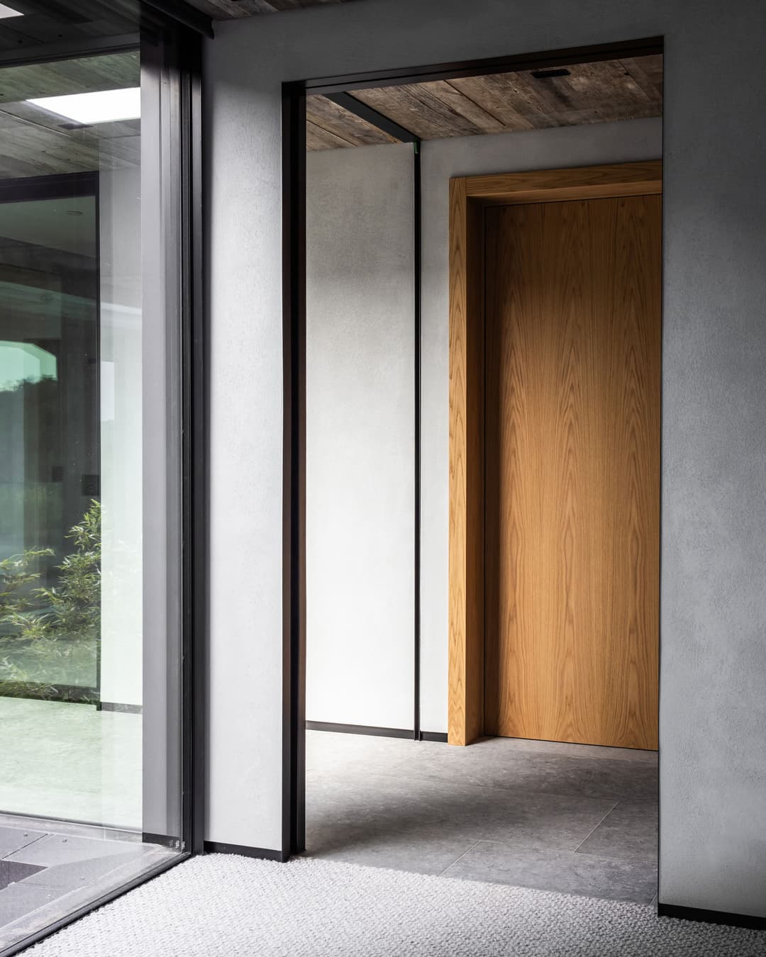 side view of a minimal sliding door fully hidden within the wall