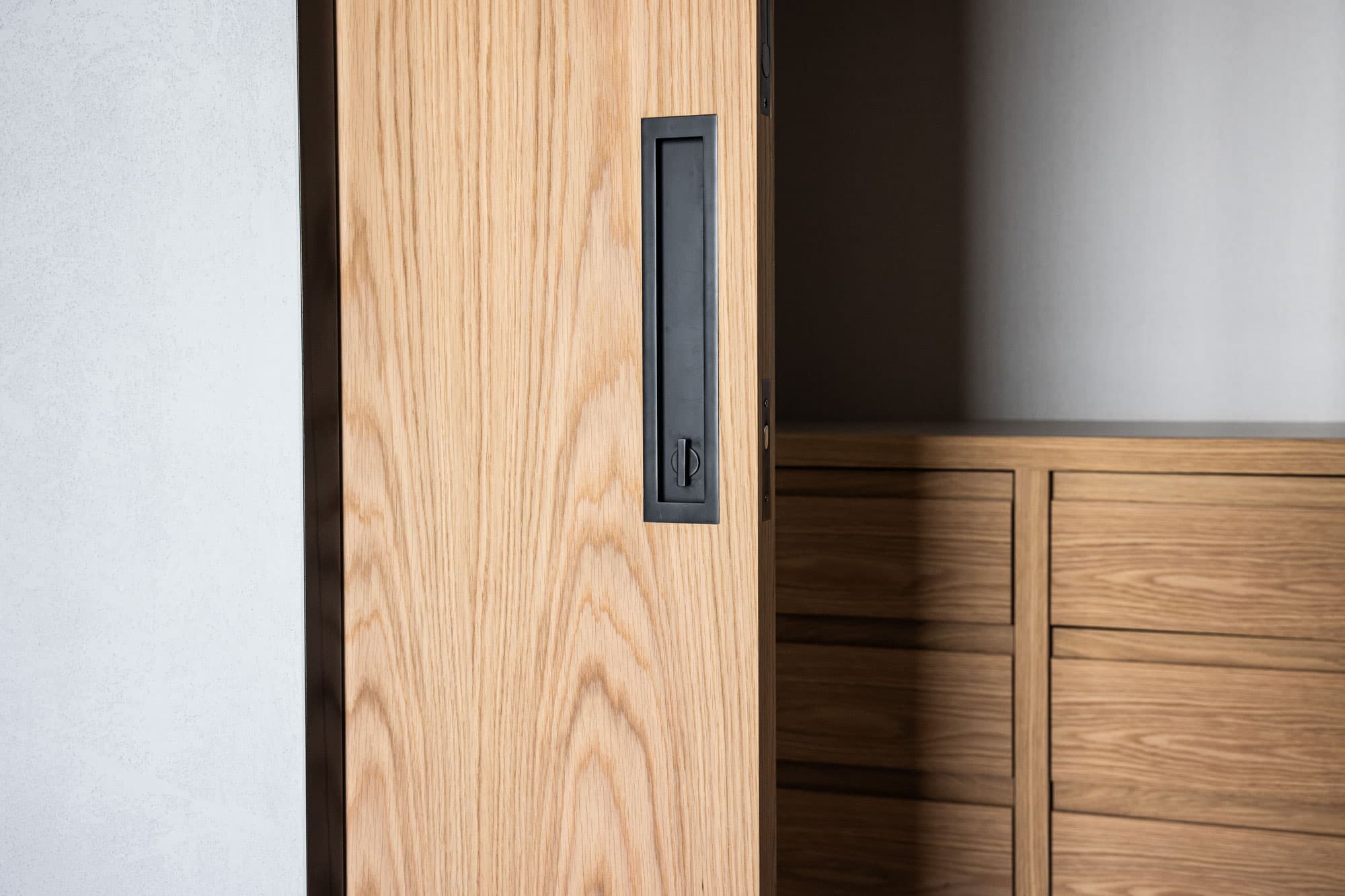 sliding timber door with black recessed pull handle