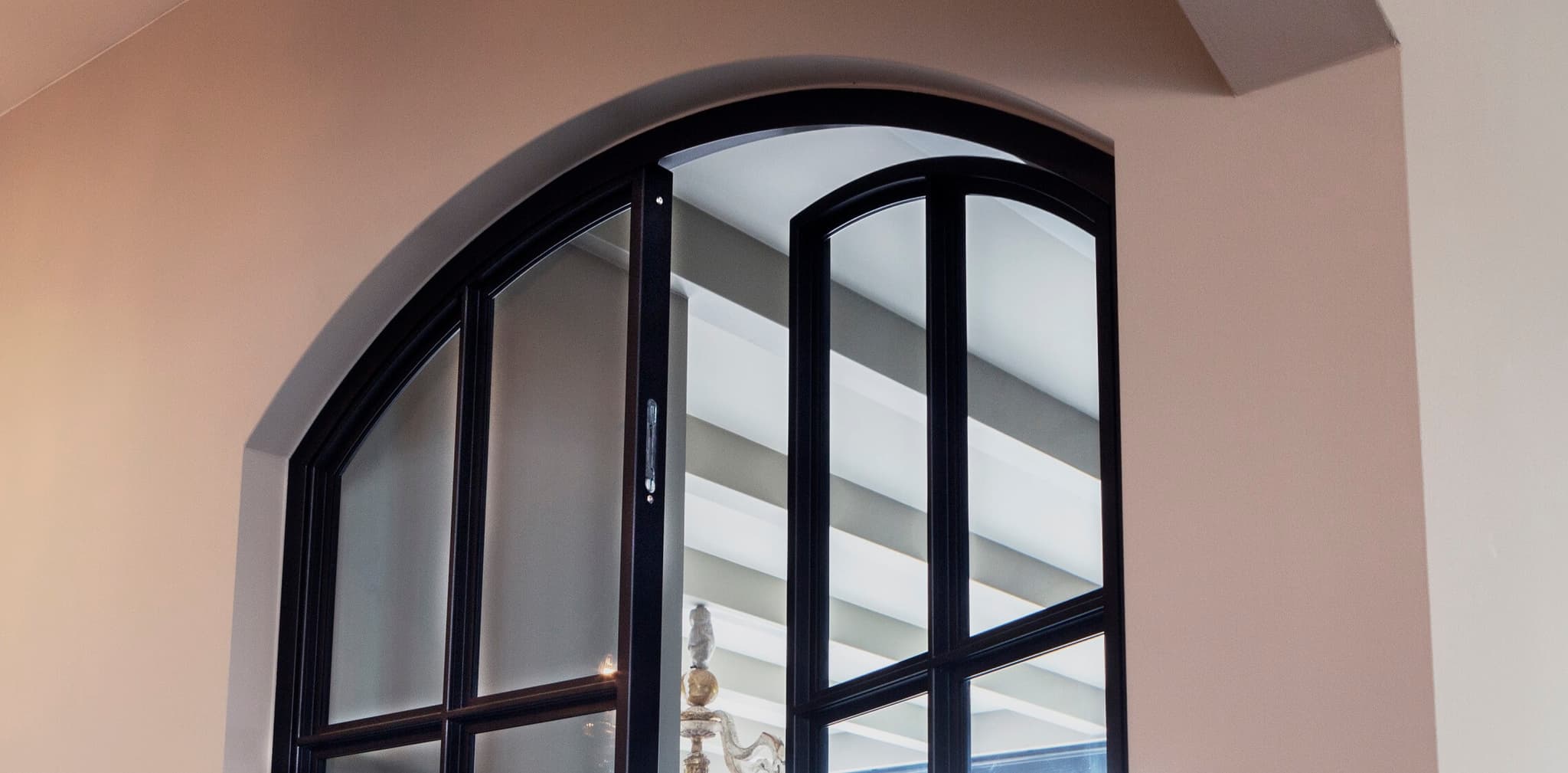 double steel glazed arched doors in entrance hall