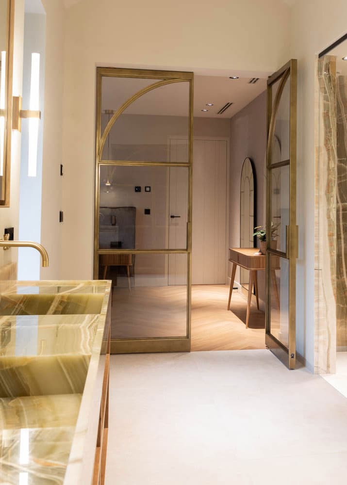 System M+ used for a steel glazed pivot door in a high-end luxury bathroom