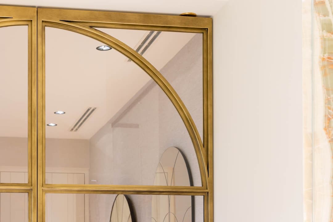 double steel glazed doors in a brushed brass finish in a luxury bathroom