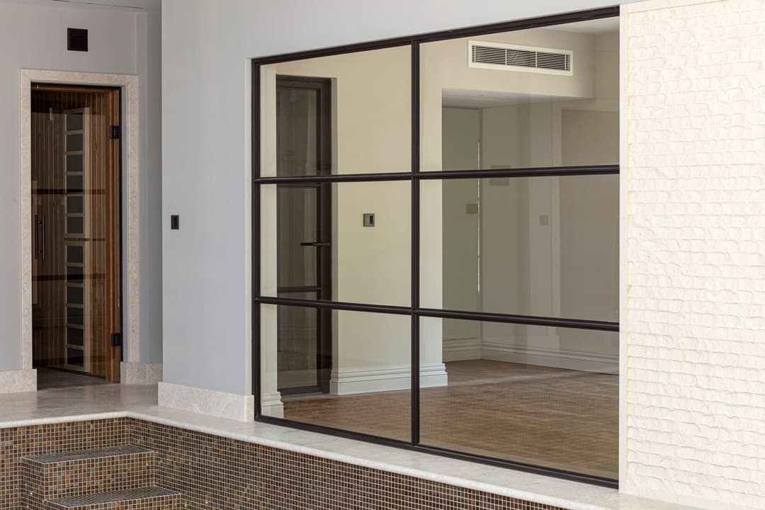 fire-rated sealed steel glazed internal door and screen in a indoor pool and wellness spa
