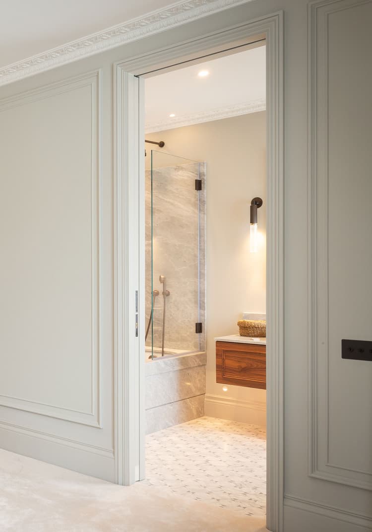 single sliding pocket door by Envo separating a bedroom and ensuite bathroom - Layzell Architects, London